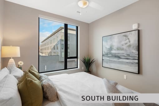 a bedroom with a large window and a ceiling fan  at Expo at Forest Park, St. Louis, MO, 63112