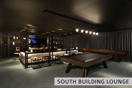 a dark room with a pool table and a tv in the background  at Expo at Forest Park, St. Louis, 63112