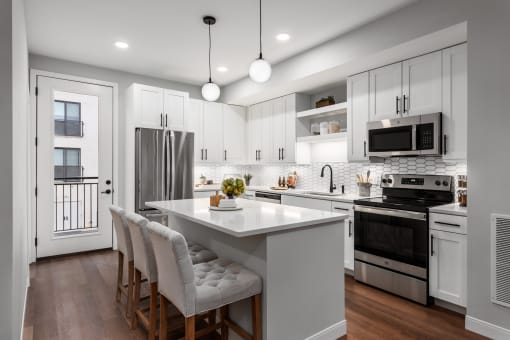 a kitchen with white cabinets and a white counter top at The Flats & Terraces at Wildhorse Village, Missouri, 63005