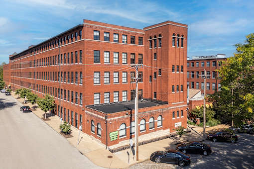 view of a large brick building on a city street at Lofts at Lafayette Square Apartments, Saint Louis, MO