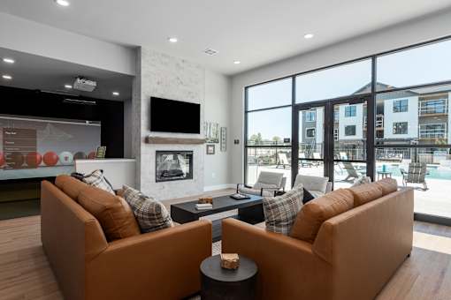 A modern living room with a fireplace and a large window.