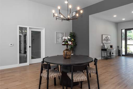 A dining room with a round table and chairs.