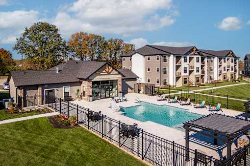 A large building with a pool in front of it.