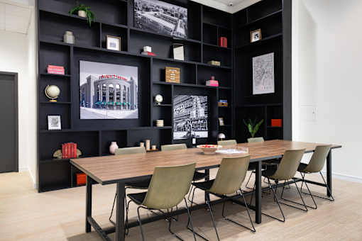 A black bookshelf with a variety of items on it.