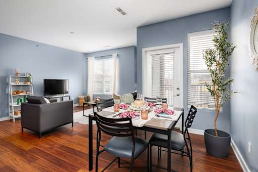 A dining room with a table set for a meal.