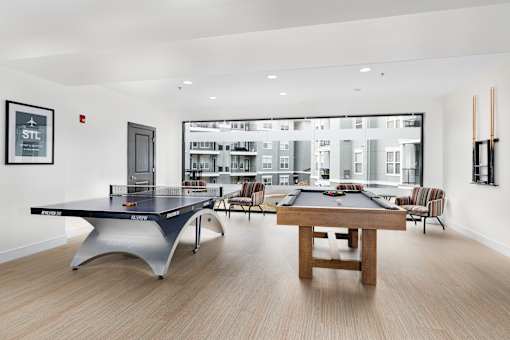 A pool table in a room with a view of a city.