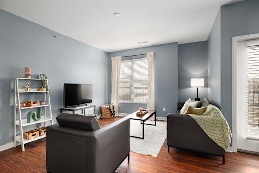 A living room with a grey couch, a television, and a coffee table.
