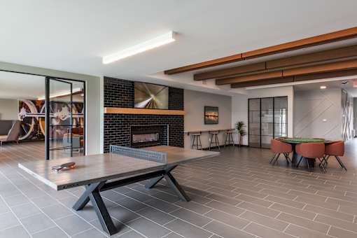 A modern living room with a fireplace and a dining table.