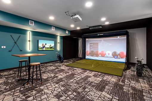 A room with a blue wall and a projection screen.