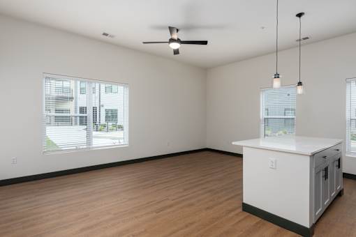 A room with a white counter and a ceiling fan.
