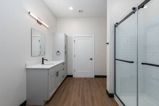 A bathroom with a white sink and a white cabinet.