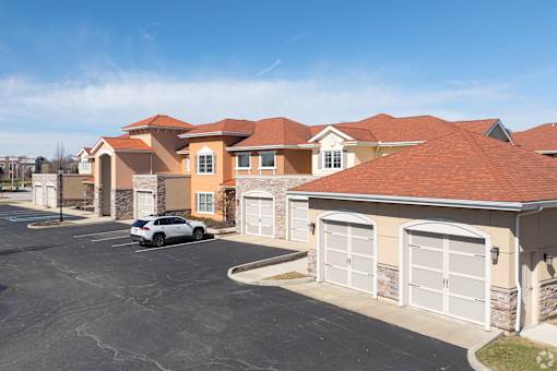 A car is parked in a driveway in front of a house.