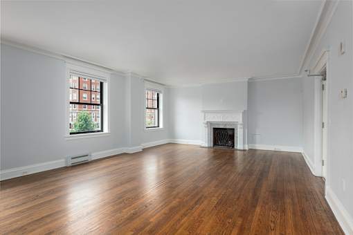 York House large living room with oak hardwood flooring, gas fireplace and crown molding.