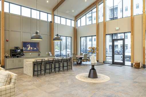 A large open space with a kitchen area and a dining table.