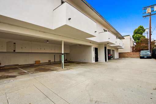 A large, empty parking garage with a clear blue sky above.