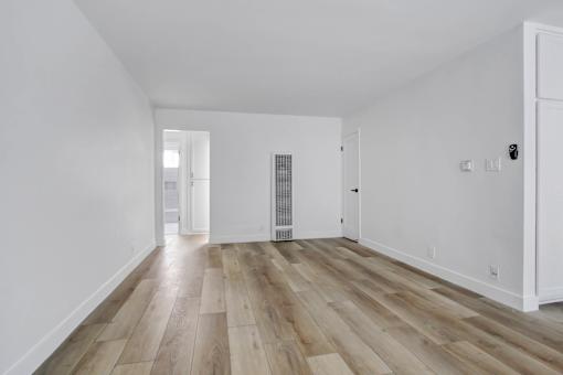 A room with wooden floors and white walls.