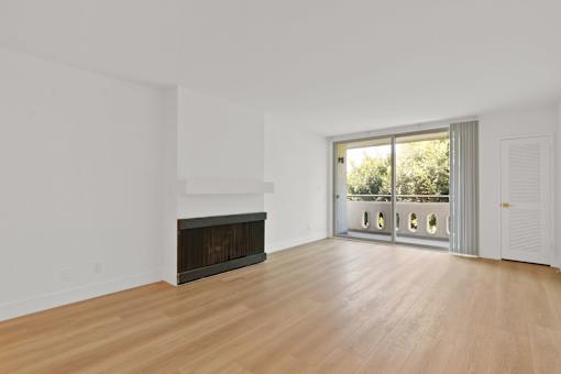 A room with a fireplace and sliding glass doors.