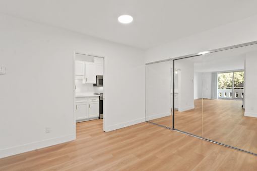 A room with a wooden floor and a glass door.