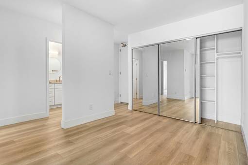 A room with a wooden floor and white walls.