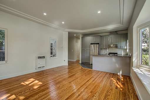 A spacious kitchen with wooden floors and a large island.