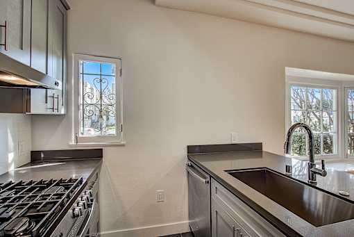 A modern kitchen with a stainless steel stove and dishwasher.