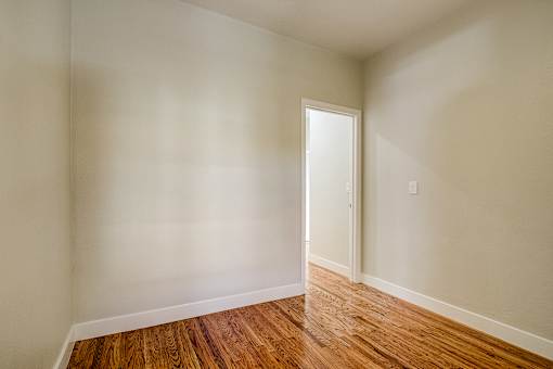 A room with a wooden floor and a door.