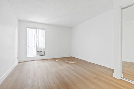 A room with wooden floors and white walls.