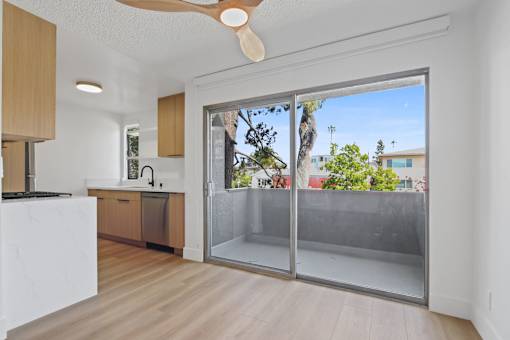 A kitchen with a white counter top and wooden cabinets.