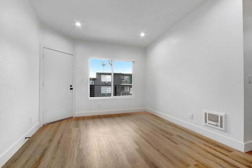 A room with wooden floors and white walls.