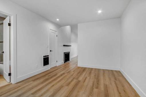 A room with wooden floors and white walls.