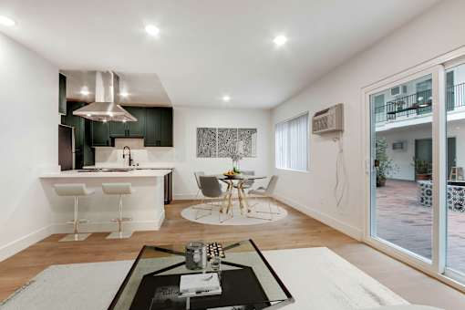 A modern kitchen with a dining table and chairs.