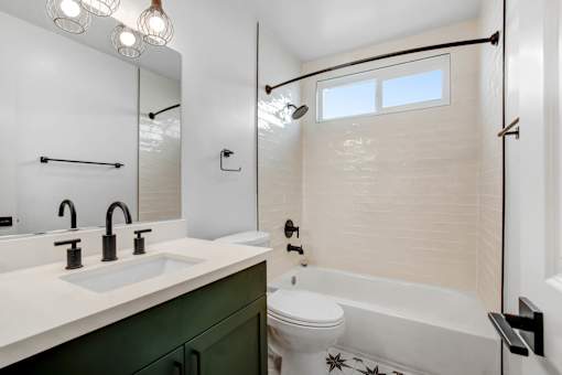 A bathroom with a white toilet and a white sink.
