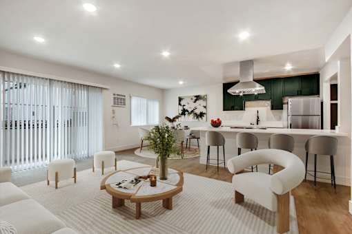 A modern living room with a white sofa set and a wooden coffee table.