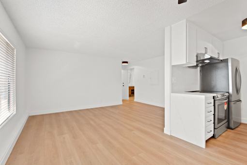 A kitchen with a stove top oven and a refrigerator.