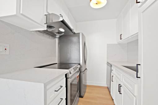 A kitchen with a stainless steel refrigerator and oven.