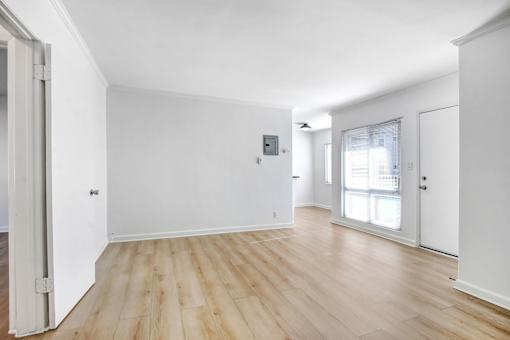 A room with wooden floors and white walls.