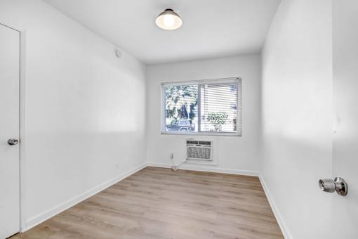A room with a window and a door.