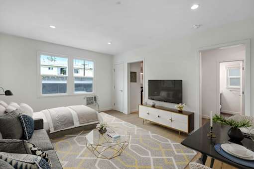 A modern bedroom with a large bed and a television.