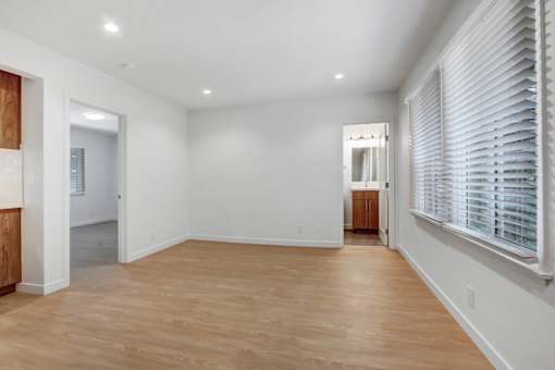 A room with wooden floors and white walls.