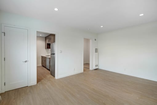 A room with a white door and a white wall.