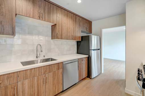 A kitchen with wooden cabinets and a white countertop.