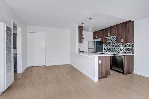 A kitchen with a white countertop and brown cabinets.