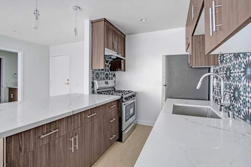 A kitchen with brown cabinets and a white countertop.