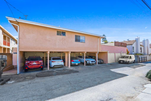 a parking lot with cars parked in front of a building