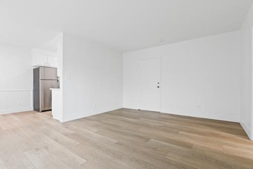 A room with a wooden floor and white walls.