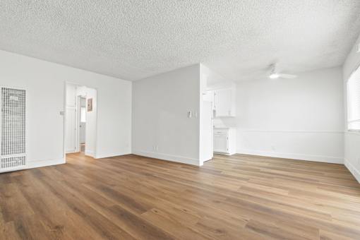 A room with wooden floors and white walls.