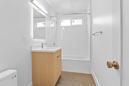 A bathroom with a sink, toilet, and shower.