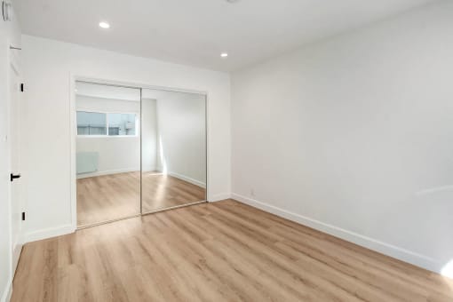 a living room with white walls and a sliding glass door