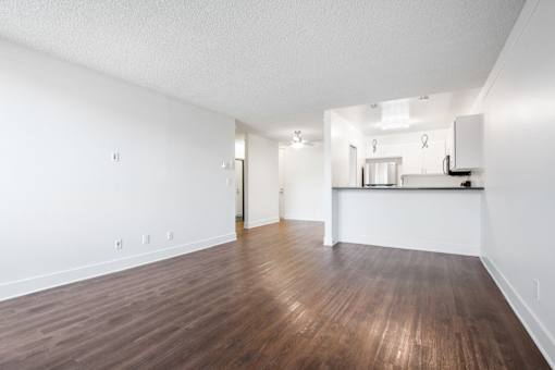 A room with wooden floors and white walls.