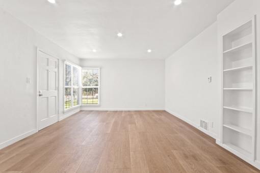 A room with wooden floors and white walls.
